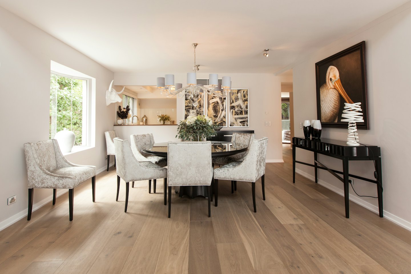 Dining room with round table and upholstered chairs.