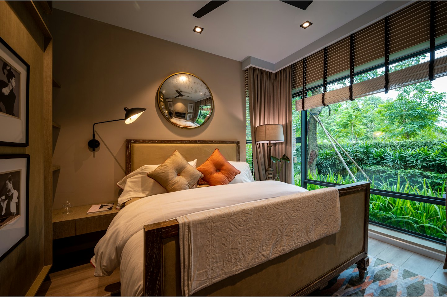 Modern bedroom with a king bed and large window overlooking greenery.