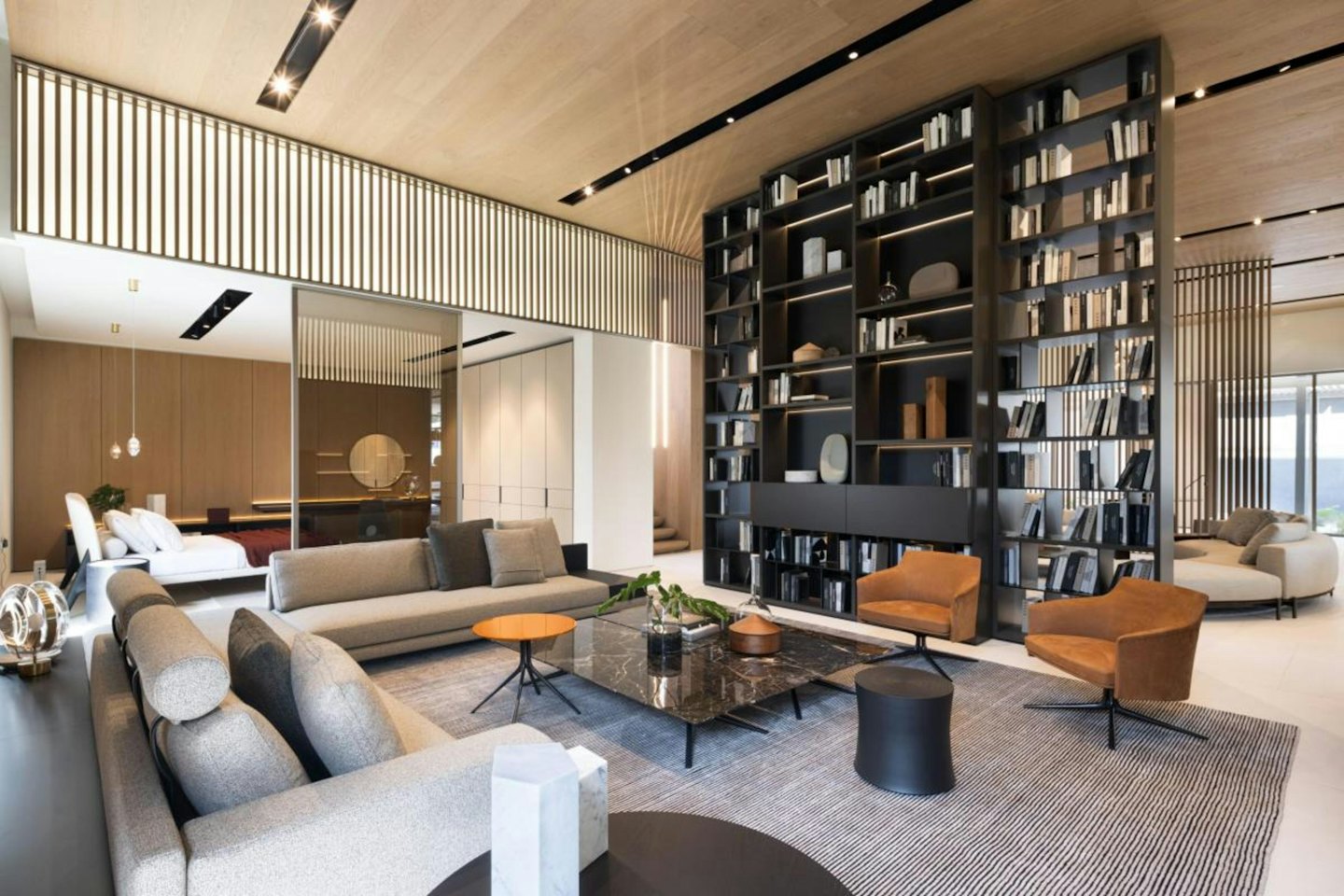 Modern living room with leather armchairs and fabric sofas.